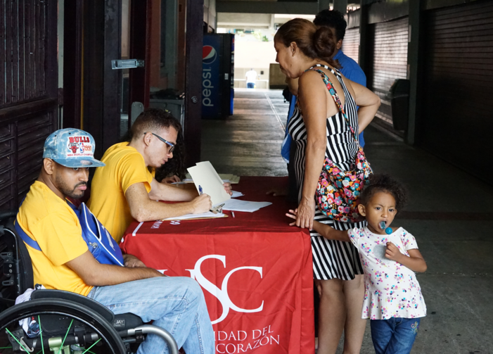 Students tend to family in need at Universidad Sagrado Corazón in San Juan, Puerto Rico. (Photo: J.D. Long-García)