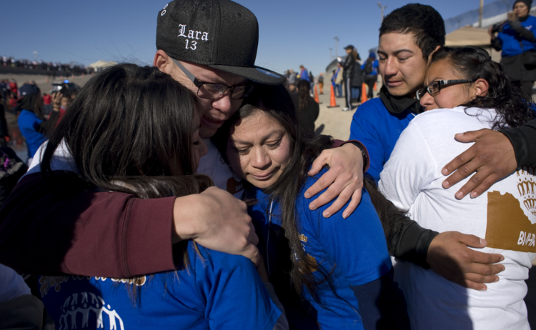 Family members embrace in El Paso, Texas, during a massive reunion called "Abrazos, No Muros" (Hugs, Not Walls) on Jan. 28. (CNS photo/David Maung)