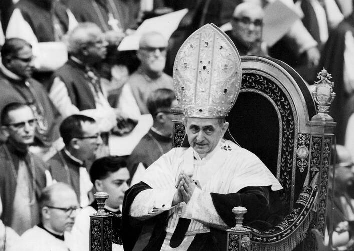 Pope Paul VI makes his way past bishops during a session of the Second Vatican Council in 1964 (CNS file photo)