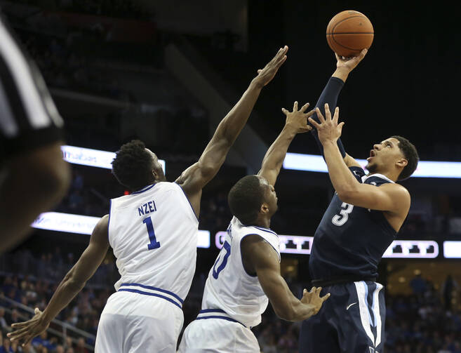 Villanova's Josh Hart (3) takes a shot past Seton Hall defenders Michael Nzei, (1) of Nigeria, and Khadeen Carrington (0) during the second half of an NCAA college basketball game, Saturday, Feb. 18, 2017, in Newark, N.J. Villanova won 92-70. (AP Photo/Mel Evans)