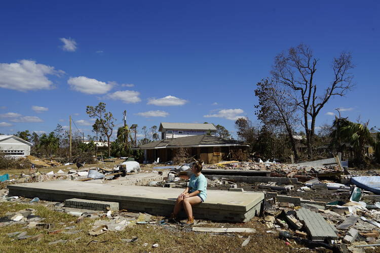 Caroline McClain, 16, sits on the ruins of her family's Mexico Beach vacation home after Hurricane Michael. Photo by Atena Sherry.