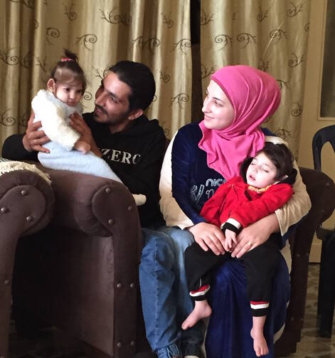 Abdul Ghaleb Edris with his 1-year-old daughter, Fatima, and his wife Souzan and their 2-year-old son, Ayham. The Syrian refugee family arrived in Rome on May 3 