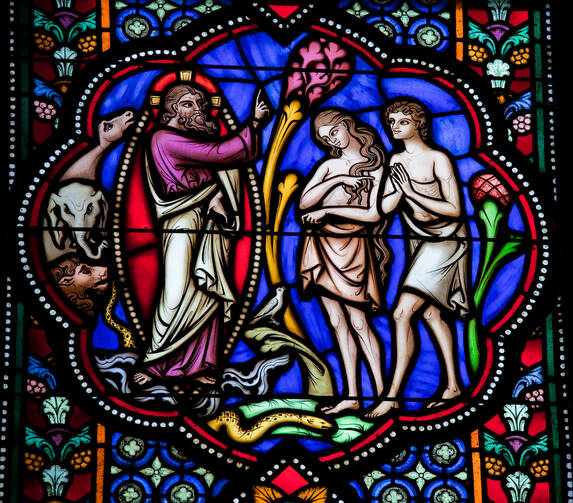 PARENTAL UNITS. Stained glass window depicting Adam and Eve in the cathedral of Brussels, Belgium.