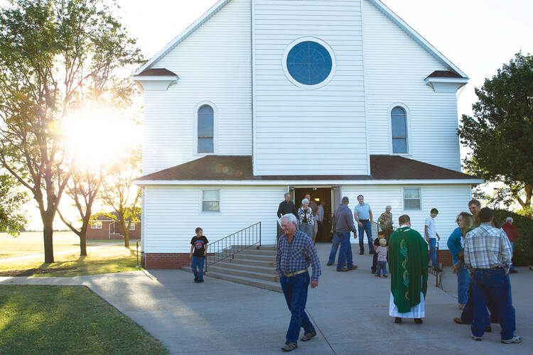 OPEN HOUSE. Churchgoers in St. Leo, Kan., after Saturday evening Mass.