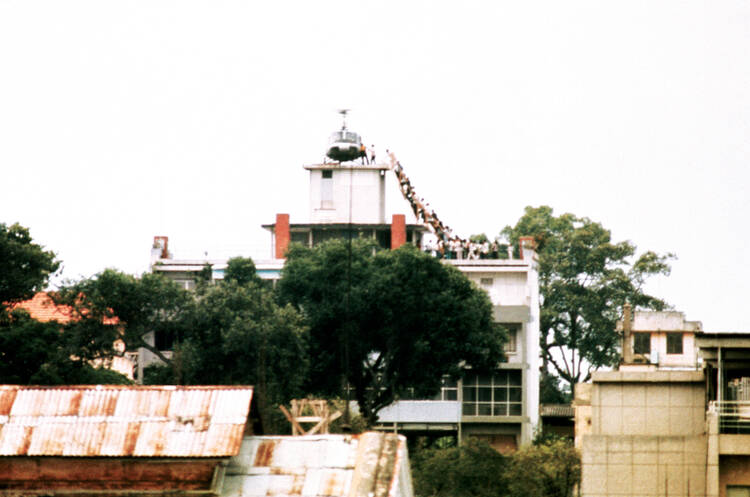 THIS IS THE END. Vietnamese board an American helicopter a half mile from the U.S. Embassy, April 29, 1975. 