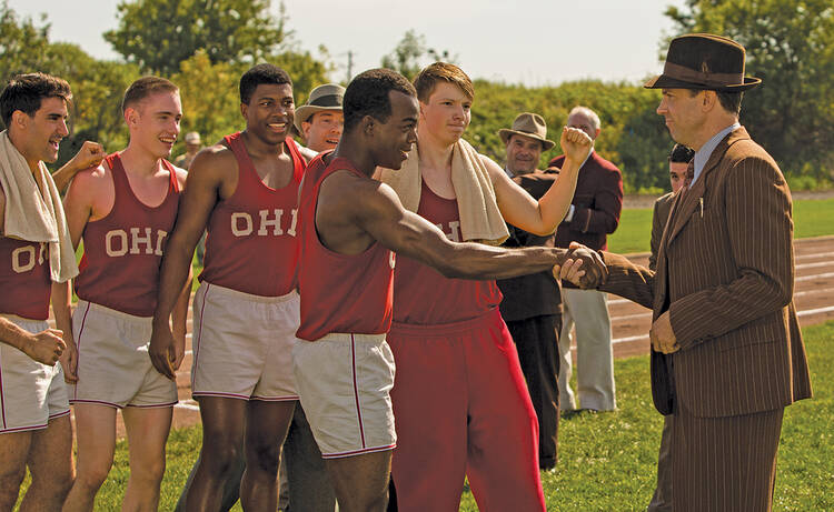 FOR THE WIN. Stephan James, center, as Jesse Owens and Jason Sudeikis, right, as Larry Snyder in “Race”