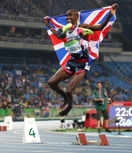 Britain's Mo Farah celebrates winning the men's 5000-meter during athletics competitions on Aug. 20. (AP Photo/Lee Jin-man)