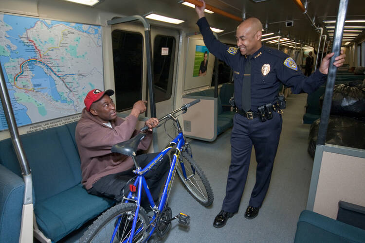 BART Police Chief Kenton Rainey, who leads a department of more than 200 officers, speaks with a passenger. Photo courtesy of BART