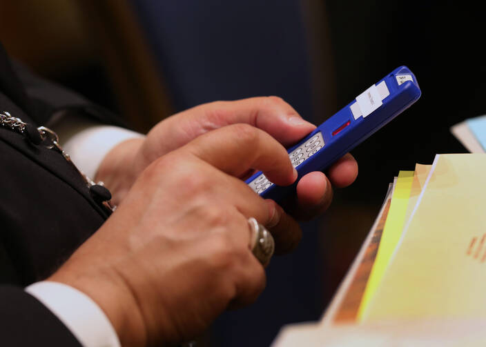 A bishop casts a vote Nov. 11 during the annual fall general assembly of the U.S. Conference of Catholic Bishops in Baltimore. (CNS photo/Bob Roller) 