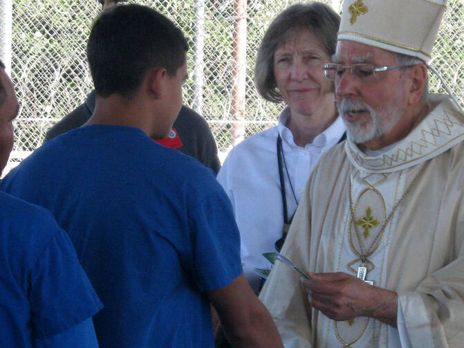 Bishop Gerald Kicanas of the Diocese of Tucson celebrated Mass at the Florence Detention Facilty on October 20, 2014. Sr. Lynn Allvin, the Chaplain at Florence Federal Detention Center, is behind him in this picture (DHS).