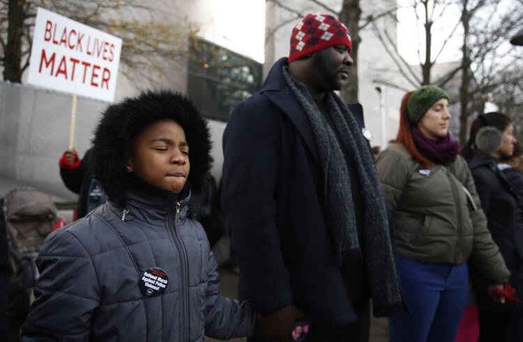 Marchers at prayer in Washington on Dec. 13 at the Justice For All national march calling for changes in the nation's criminal justice system. (CNS photo/Jim Bourg, Reuters)