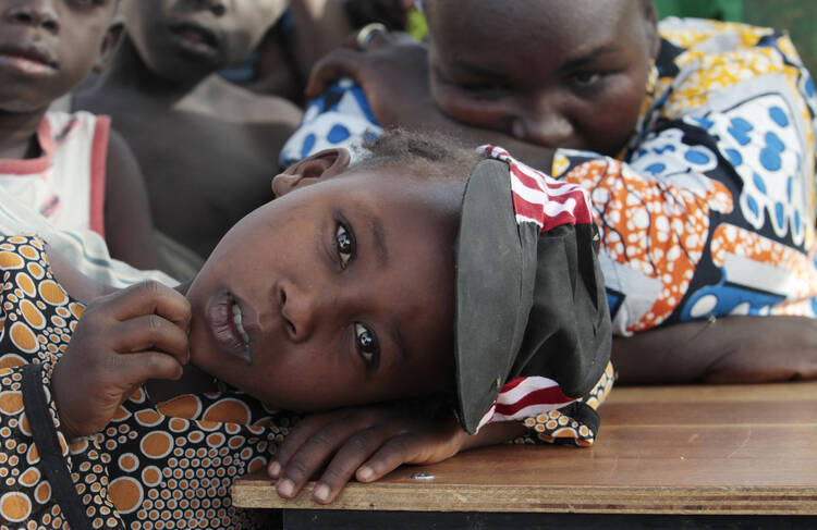 A girl displaced as a result of Boko Haram attack in the northeast region of Nigeria rests her head on a desk at a camp for internally displaced people in Yola Jan. 13. (CNS photo/Afolabi Sotunde, Reuters) 