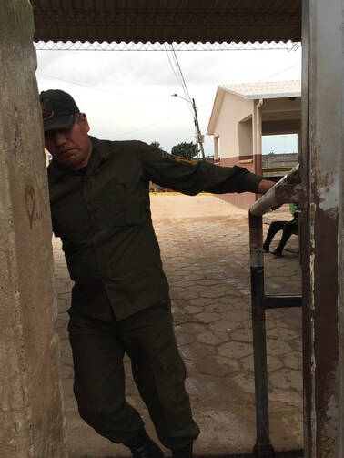 A guard closes the gate to the Palmasola prison in Santa Cruz, Bolivia, July 8. On July 10 Pope Francis is scheduled to visit the prison, infamous for violence, overcrowding and prisoners' families having to pay for their upkeep. (CNS photo/David Agren)