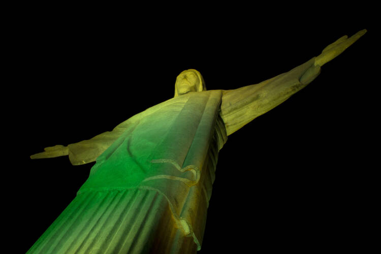 Rio's Christ the Redeemer Statue glows green to help kickoff the 2014 FIFA World Cup.