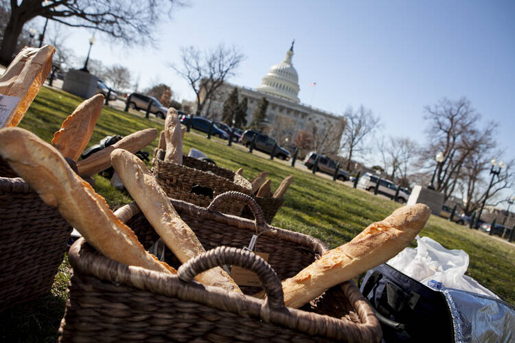 Baskets of bread sit outside U.S. Capitol as faith leaders prepare news conference on budget proposals.