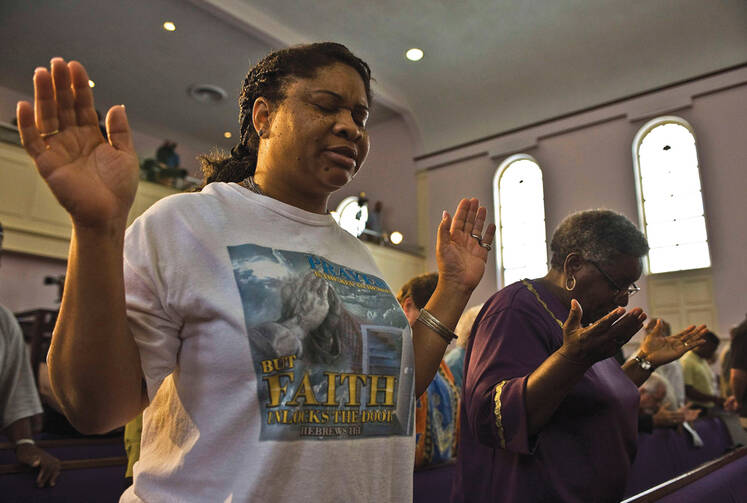 SEE THE VICTIM. Women pray at the New Life Word Center Church in Sanford, Fla., after the George Zimmerman murder trial.