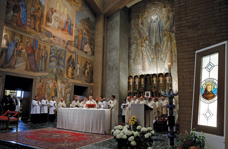 A CONTROVERSIAL CANONIZATION. An image of Blessed Junípero Serra, right, is seen as Pope Francis celebrates Mass in Rome on May 2.
