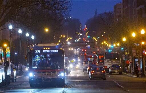 Metro bus makes it way down 16th street in in downtown Washington, Wednesday, March 16, 2016. (AP Photo/Pablo Martinez Monsivais)