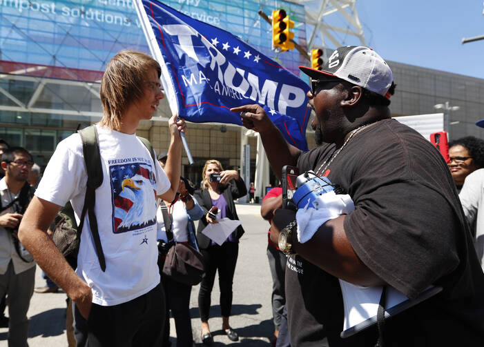 Healthy Dialogue? Zack W., left, listens to Maurice Hardwick at a protest while Republican presidential candidate Donald Trump delivered an economic policy speech to the Detroit Economic Club in Detroit, Monday, Aug. 8, 2016. (AP Photo/Paul Sancya)