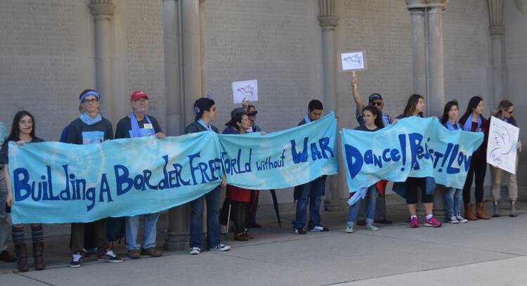 Pax Christi Toronto members gather in 2015 at the "Soldiers' Tower on campus at the University of Toronto, during its annual Peace Walk to mark The International Day of Peace. (Photo courtesy of Pamela Carriere)