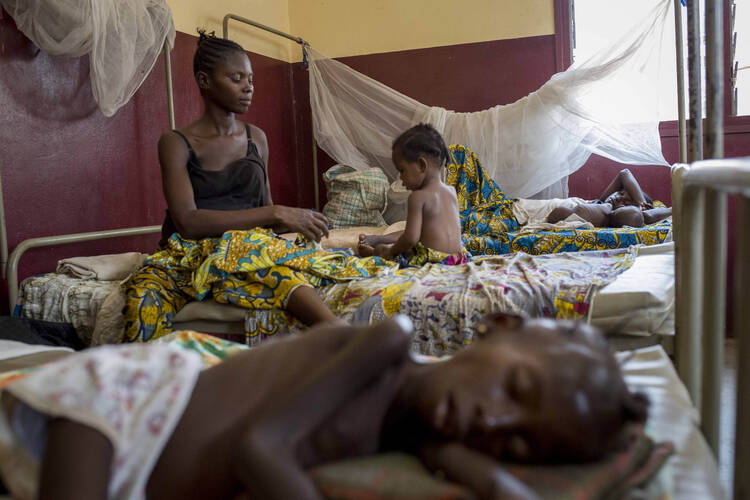 A mother tends to her child, who is suffering from malnutrition, at a pediatrics hospital in Bangui, Central African Republic, on Feb. 25. 