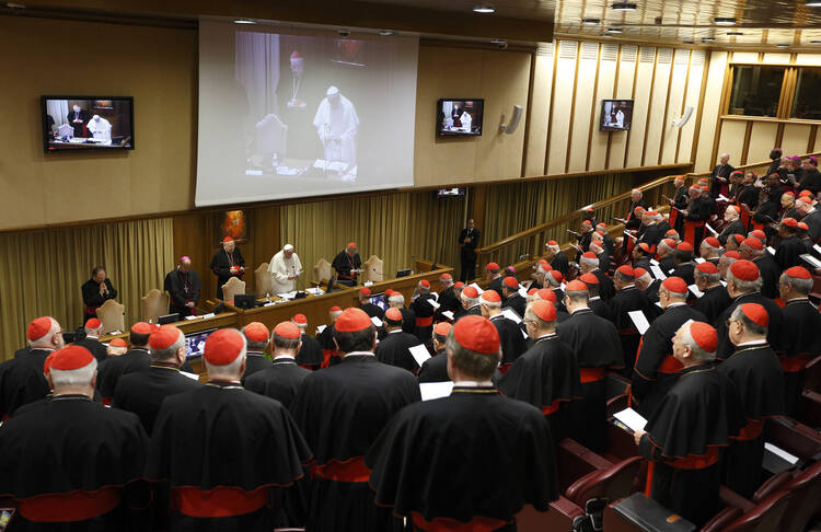 Pope Francis leads opening prayer during a meeting of cardinals in the synod hall at the Vatican Feb. 20.