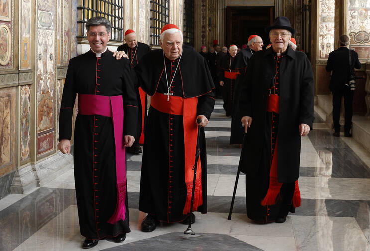 Cardinal Bernard F. Law and Cardinal Agostino Cacciavillan, former apostolic nuncio to the United States, leave after Pope Francis' audience with members of the Roman Curia in Clementine Hall at the Vatican Dec. 22, 2014 (CNS photo/Paul Haring). 