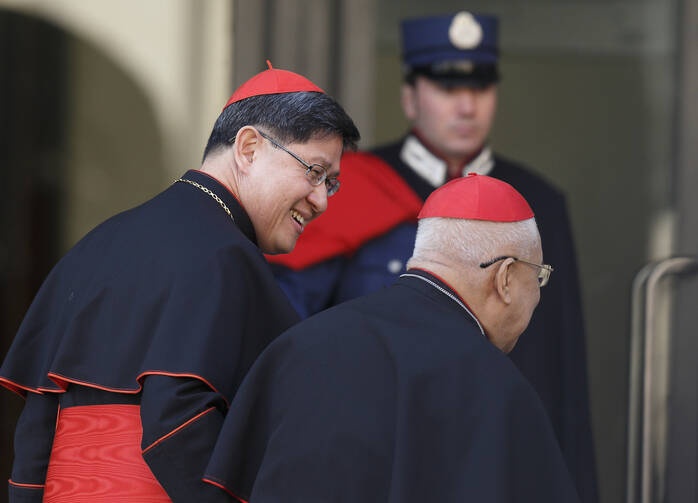 Cardinals Luis Tagle of Manila and Ricardo J. Vidal, retired archbishop of Cebu, Philippines, arrive for the first general congregation meeting in the synod hall at the Vatican March 4. (CNS / Paul Haring)