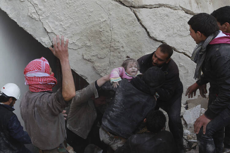 A child pulled from the rubble after an air strike in Aleppo