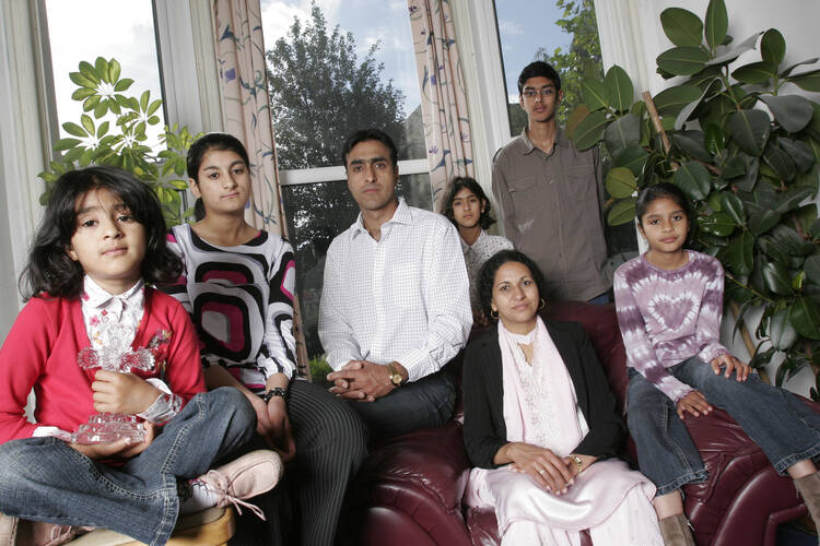 From left to right, Leena, Anniesa, Nissar, Sarah, Kubra, Issar, and Miriam Hussain, a Christian family who have been threatened with death for converting from Islam in West Yorkshire, England. Photo by Rii Schroer, courtesy of Nissar Hussain