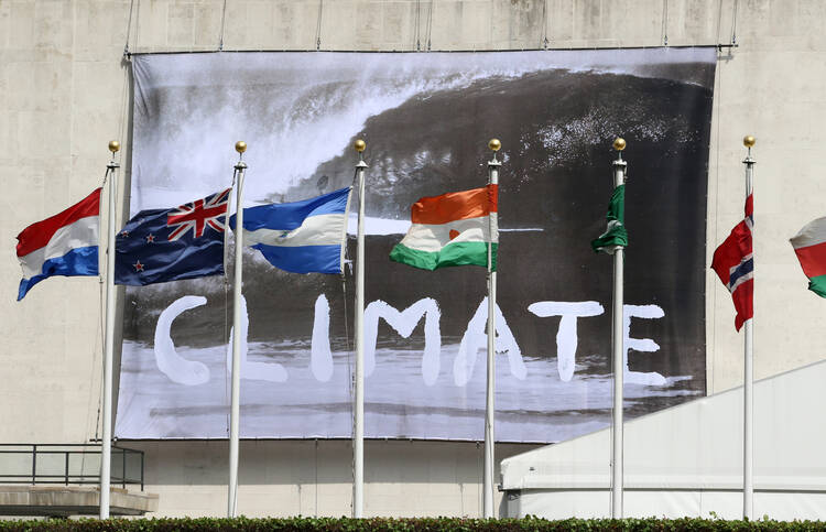 A "Climate" banner is seen hanging from the U.N. General Assembly building in New York City June 30, a day after the U.N. hosted a high-level event on climate change. (CNS photo/Gregory A. Shemitz)