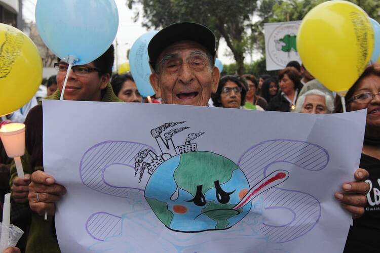 Valerio Mendoza, 83, joins a Nov. 30 vigil for climate change on the eve of the U.N. climate summit in Lima, Peru. (CNS photo/Barbara Fraser)