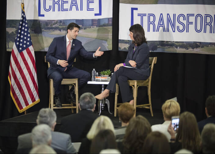 House Speaker Paul Ryan, R-Wis., talks with Heather Reynolds, CEO and president of Catholic Charities Fort Worth, Texas, during a town hall meeting on poverty April 3 at the charity's Fort Worth campus.