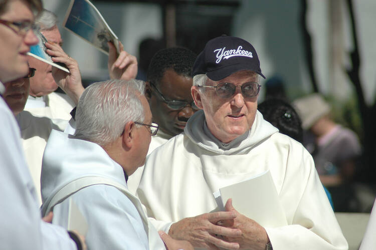 Father Rene Robert, with hat, is pictured during a 2015 procession for Mass at the Cathedral Basilica of St. Augustine in Florida. The 71-year-old priest was found dead April 18 in Burke County, Ga. (CNS photo/Jean Gonzalez, Florida Catholic).