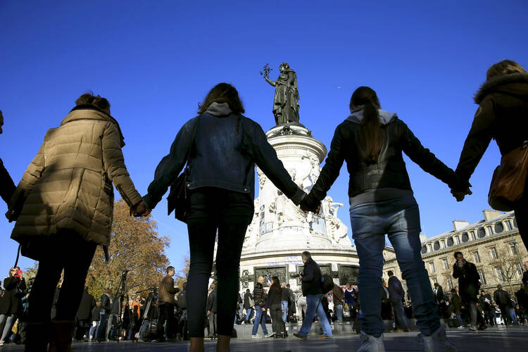 People in Paris form a human solidarity chain Nov. 15 near the site of the attack at the Bataclan concert hall (CNS photo/Pascal Rossignol, Reuters). 