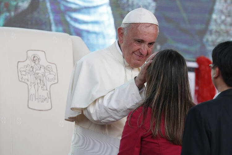 Pope Francis greets a young woman during a meeting with youths in Asuncion, Paraguay, July 12, 2015 (Paul Haring, CNS).