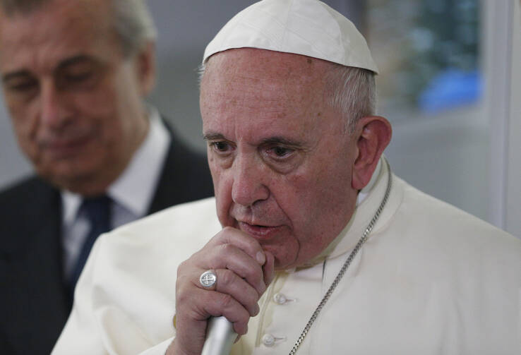 Pope Francis answers questions from journalists aboard his flight from Ciudad Juarez, Mexico, to Rome, Feb. 17 (CNS photo/Paul Haring).