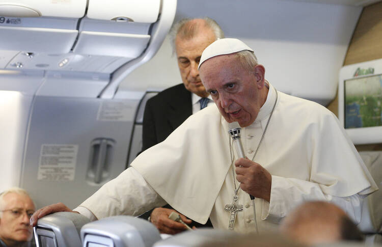 Pope Francis answers questions from journalists aboard his flight from Bangui, Central African Republic, to Rome Nov. 30 (CNS photo/Paul Haring).