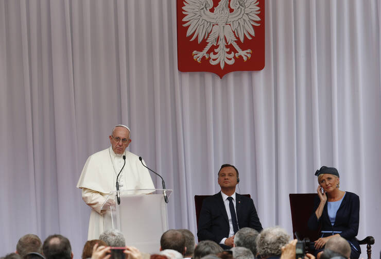 Pope Francis speaks as Polish President Andrzej Duda and first lady Agata Kornhauser-Duda attend a meeting with government authorities and the diplomatic corps in the courtyard of Wawel Royal Castle in Krakow, Poland, July 27 (CNS photo/Paul Haring).