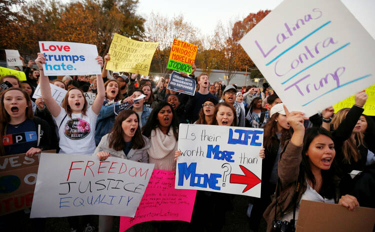 Demonstrators shout and hold signs in front of the White House in Washington Nov. 10 following President-elect Donald Trump's victory in the Nov. 8 election (CNS photo/Kevin Lamarque, Reuters).