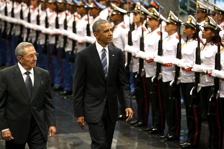 WALKING INTO HISTORY. Cuban President Raul Castro and U.S. President Barack Obama review Cuban soldiers during a welcome ceremony for Obama at the Palace of the Revolution in Havana, March 21 (CNS photo/Jonathan Ernst, Reuters).