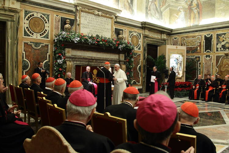 Pope Francis greets Cardinal Angelo Sodano, dean of the College of Cardinals, during the traditional Christmas greetings to the Roman Curia in the Clementine Hall of the Apostolic Palace at the Vatican, Dec. 21 (CNS photo/Evandro Inetti, pool). 