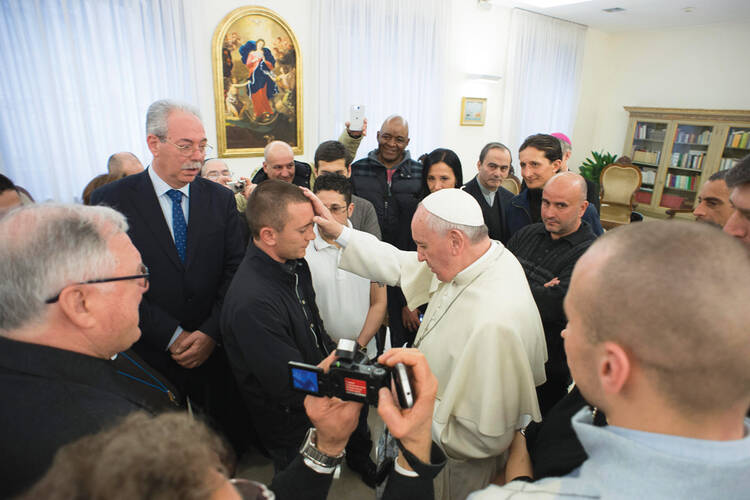 PRISON BREAK. Pope Francis blesses prisoners from Pisa and Pianosa jails during a private meeting, Feb.19.