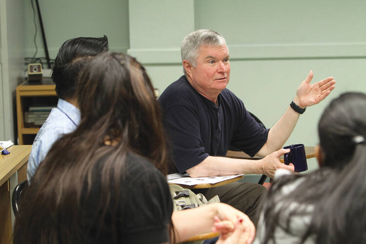 TAKING CHARGE. John Lundy leads a class in English as a Second Language as a member of the Ignatian Volunteer Corps, in the South Bronx section of New York City. 