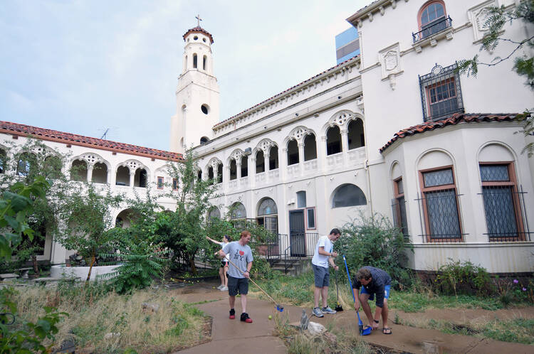 Christ in the City missionaries clean up the courtyard of Seton House in Denver, July 2012. Nearly 30 missionaries from across the country moved into the former convent to begin work serving the homeless. 