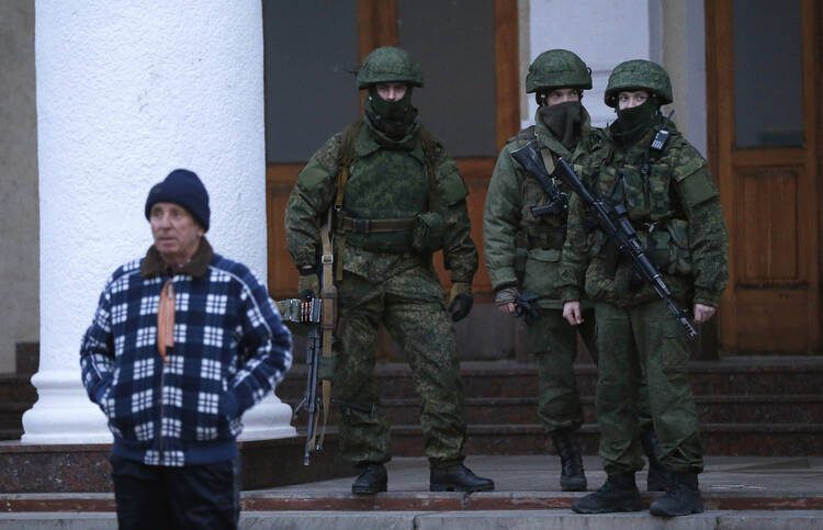 Unidentified armed men patrol the airport in Crimea, Ukraine, on Feb. 28. 