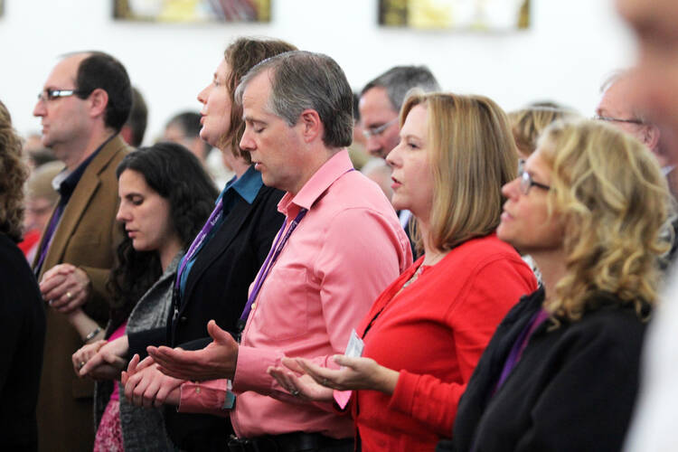 Attendees of Catholic Charities USA's annual gathering in Charlotte, N.C., praying during an Oct. 5 Mass at St. Joseph Vietnamese Catholic Church (CNS photo /Patricia L. Guilfoyle, Catholic Herald).