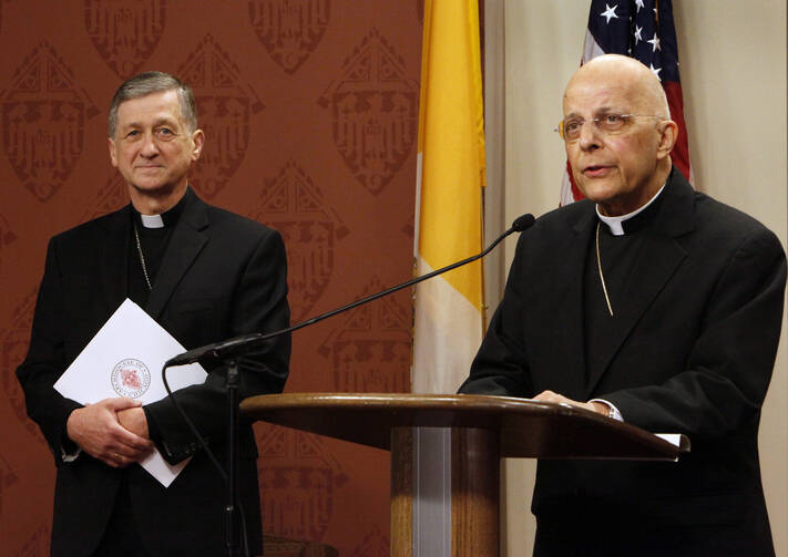 Cardinal Francis E. George introduces Bishop Blase J. Cupich of Spokane, Washington, left, as the next archbishop of Chicago, Sept. 20 (CNS photo/Karen Callaway, Catholic New World).