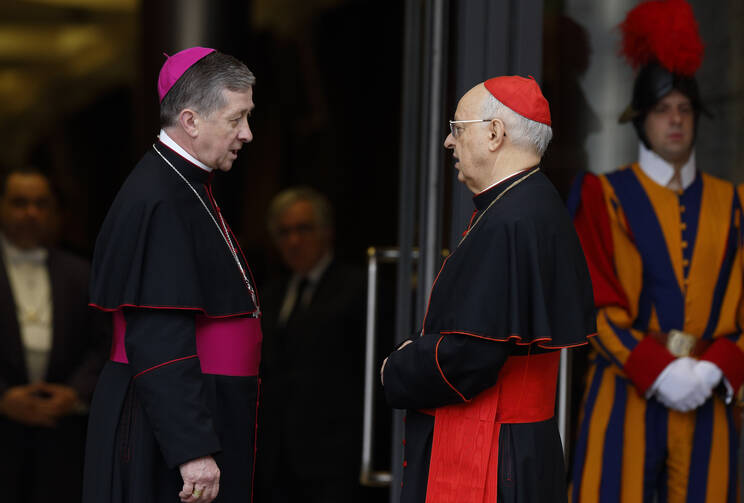 Archbishop Blase J. Cupich of Chicago and Cardinal Lorenzo Baldisseri, general secretary of the Synod of Bishops, talk before a session of the Synod of Bishops on the family at the Vatican Oct. 16. (CNS photo/Paul Haring)