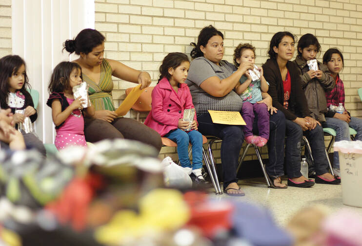 THE HEART OF TEXAS. Migrants sit at the Sacred Heart Catholic Church temporary shelter in McAllen, Tex. 